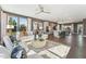 Open-concept living room with modern furniture, hardwood floors and lots of natural light, seamless to kitchen at 600 Hedrick Ridge Road # 310 209, Cary, NC 27519