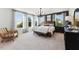 Bright main bedroom with large windows, contemporary furnishings, and plush carpeting at 600 Hedrick Ridge Road # 310 209, Cary, NC 27519