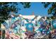 Colorful mural on a brick building featuring artistic depictions and whimsical elements at 600 Hedrick Ridge Road # 310 209, Cary, NC 27519