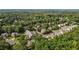 Aerial view of homes, winding roads, and mature trees in a neighborhood at 603 Everglades Dr, Mebane, NC 27302