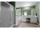 Bathroom featuring a glass-enclosed shower, large tub, double vanity, and green walls at 603 Everglades Dr, Mebane, NC 27302