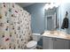 Bathroom with a light blue wall, toilet, vanity, and cartoon shower curtain at 603 Everglades Dr, Mebane, NC 27302
