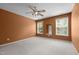 Bedroom with orange walls, light carpet, and two bright windows at 603 Everglades Dr, Mebane, NC 27302