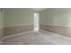 Carpeted bedroom with two-tone walls and an open door to another room at 603 Everglades Dr, Mebane, NC 27302