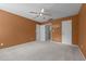 Bedroom with orange walls, light carpet, and two door openings at 603 Everglades Dr, Mebane, NC 27302