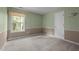 Carpeted bedroom with neutral walls and a bright window at 603 Everglades Dr, Mebane, NC 27302