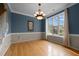 Bright dining room features hardwood floors, large window, and decorative chandelier at 603 Everglades Dr, Mebane, NC 27302