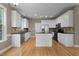 Modern kitchen featuring granite countertops, stainless steel appliances, white cabinets, and center island at 603 Everglades Dr, Mebane, NC 27302