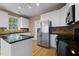 Bright kitchen with stainless steel appliances, granite countertops, and ample cabinet space at 603 Everglades Dr, Mebane, NC 27302
