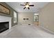 Carpeted living room features fireplace and mount for TV at 603 Everglades Dr, Mebane, NC 27302