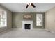 Carpeted living room with fireplace and lots of natural light at 603 Everglades Dr, Mebane, NC 27302
