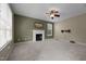 Spacious living room features a fireplace, fan, and natural light at 603 Everglades Dr, Mebane, NC 27302