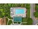 Overhead view of a community pool with lounge chairs, sunshades, and a green bath house at 603 Everglades Dr, Mebane, NC 27302
