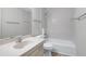 Standard bathroom featuring a sink, toilet and bathtub with white tile at 606 Oak Tree Dr, Chapel Hill, NC 27517