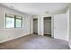 Bedroom features carpet, a large window, and built-in closets with white doors at 606 Oak Tree Dr, Chapel Hill, NC 27517