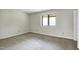 Neutral bedroom with carpet flooring features a large window allowing ample natural light at 606 Oak Tree Dr, Chapel Hill, NC 27517