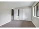 Bedroom features cozy carpet, a window, and convenient closet space at 606 Oak Tree Dr, Chapel Hill, NC 27517