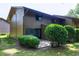 A home exterior featuring a patio, green shrubs, and wooden siding, providing a private outdoor space at 606 Oak Tree Dr, Chapel Hill, NC 27517