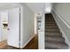 Hallway offers access to carpeted stairs and a kitchen with neutral décor at 606 Oak Tree Dr, Chapel Hill, NC 27517