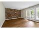 Living room featuring a brick accent wall and patio access at 606 Oak Tree Dr, Chapel Hill, NC 27517