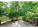 A concrete patio surrounded by lush greenery, offering a serene outdoor retreat with a vintage lamp post at 606 Oak Tree Dr, Chapel Hill, NC 27517