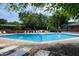 A community pool surrounded by lounge chairs, providing a relaxing and social atmosphere at 606 Oak Tree Dr, Chapel Hill, NC 27517