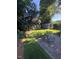 Backyard with a stone patio, furniture, a storage shed, and lush greenery, creating a cozy outdoor space at 627 New Road, Raleigh, NC 27608