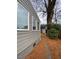 Back exterior of home, showing lawn and stone walkway, with large tree at 627 New Road, Raleigh, NC 27608