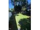 Manicured backyard lawn with stepping stones and mature trees at 627 New Road, Raleigh, NC 27608