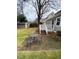 Backyard featuring a patio with an outdoor dining set and detached storage shed at 627 New Road, Raleigh, NC 27608