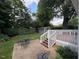 Green backyard with a detached shed and patio seating area at 627 New Road, Raleigh, NC 27608
