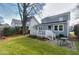 Beautiful backyard with a spacious deck, complemented by a dining area and lush green lawn at 627 New Road, Raleigh, NC 27608