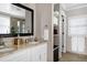 Bathroom featuring dual sinks, granite countertops, and a framed mirror at 627 New Road, Raleigh, NC 27608