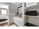 Bright bathroom featuring dual sinks, granite countertops, and a linen closet at 627 New Road, Raleigh, NC 27608
