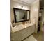 Bright bathroom with double sinks, granite countertops, and a framed mirror at 627 New Road, Raleigh, NC 27608