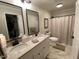 Lovely bathroom featuring double sinks, granite counters, and stylish fixtures at 627 New Road, Raleigh, NC 27608