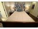Bedroom with a queen bed, blue accents, and hardwood floors at 627 New Road, Raleigh, NC 27608