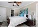 Comfortable bedroom with a ceiling fan, blue accents, and dark hardwood floors at 627 New Road, Raleigh, NC 27608