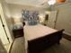 Cozy bedroom with a queen bed, soft lighting, and hardwood floors at 627 New Road, Raleigh, NC 27608