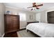 Bright bedroom with dark floors, light walls, and a wooden dresser at 627 New Road, Raleigh, NC 27608