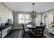 Traditional dining room with hardwood floors, a round table, and a large window with natural lighting at 627 New Road, Raleigh, NC 27608