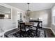 Dining room featuring hardwood floors, a round table, a modern light fixture, and a patterned accent wall at 627 New Road, Raleigh, NC 27608