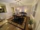 Dining area featuring a round table, wood flooring, a modern light fixture, and views into the kitchen at 627 New Road, Raleigh, NC 27608