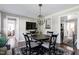 Cozy dining area with a round wood table, a decorative light fixture, and hardwood flooring at 627 New Road, Raleigh, NC 27608