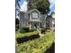 Charming two-story home featuring a well-manicured lawn and beautiful, mature landscaping at 627 New Road, Raleigh, NC 27608
