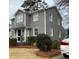 Charming two-story home with gray siding, white trim, and manicured landscaping at 627 New Road, Raleigh, NC 27608