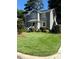 Well-maintained two-story home with lush landscaping and a neatly manicured lawn at 627 New Road, Raleigh, NC 27608