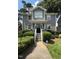 Attractive two-story home featuring gray siding, manicured shrubbery, and a welcoming entrance at 627 New Road, Raleigh, NC 27608