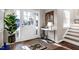 Bright foyer featuring a white door with sidelights, tiled floor, and decoratively furnished with console table at 627 New Road, Raleigh, NC 27608