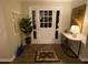 Inviting foyer featuring a tiled floor and a classic white front door with sidelights at 627 New Road, Raleigh, NC 27608
